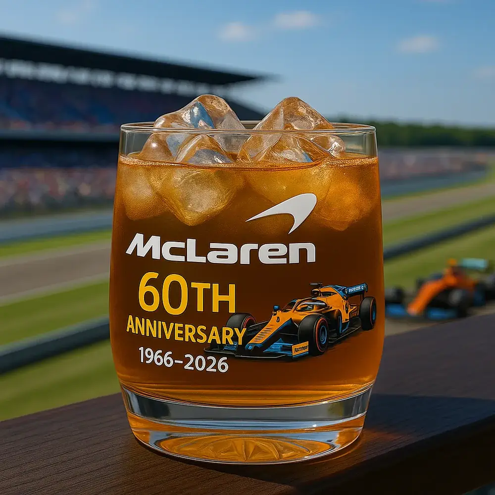 McLaren 60th Anniversary Commemorative Christmas Whiskey Glass 3 A McLaren sixtieth anniversary glass with ice positioned overlooking a racetrack!
