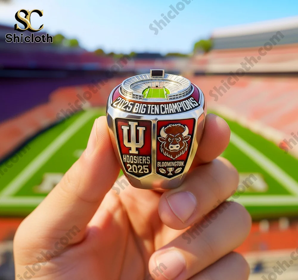 Championship ring held in hand with stadium detailing on top in front of a football field!
