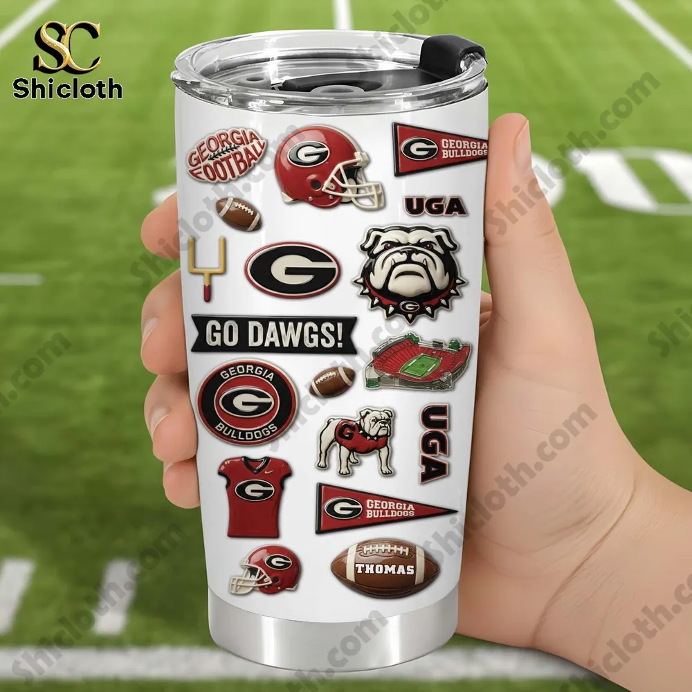 Hand holding a Georgia Bulldogs football tumbler on a field!