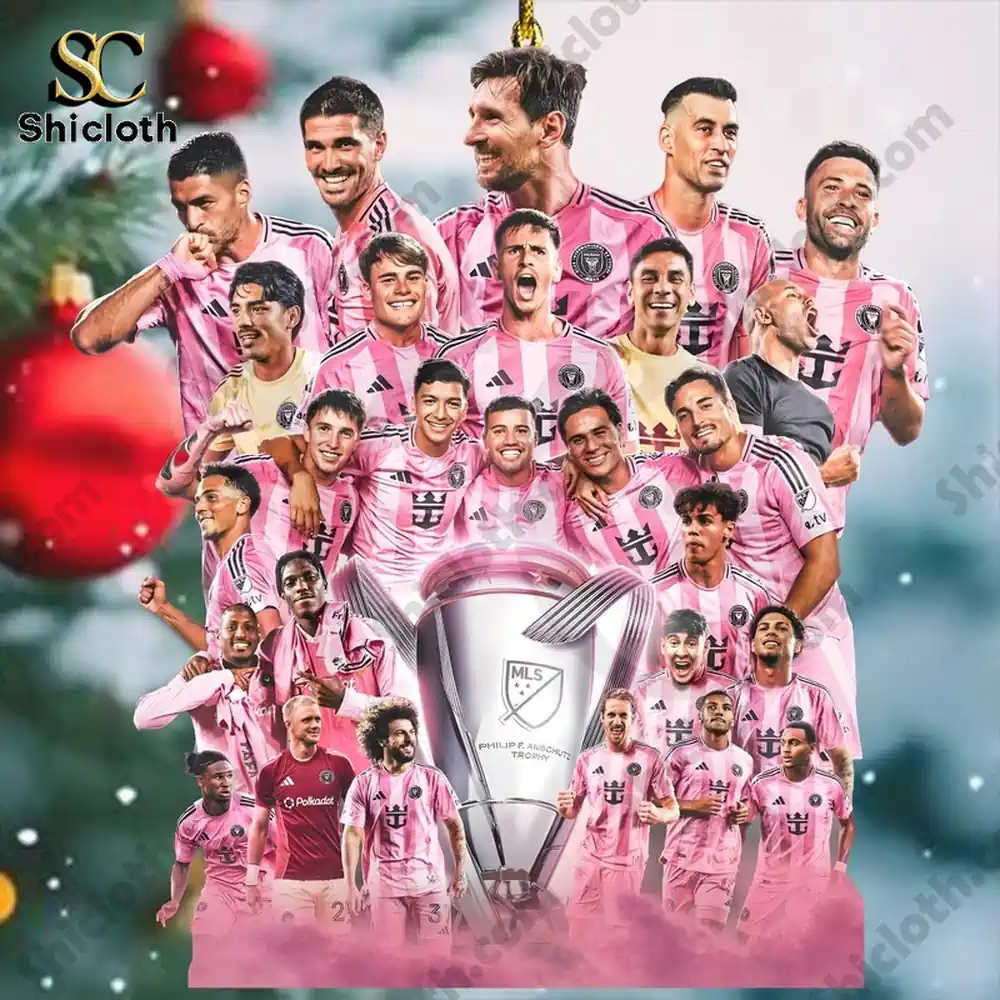 Group of soccer players in pink uniforms gathered around a large trophy!