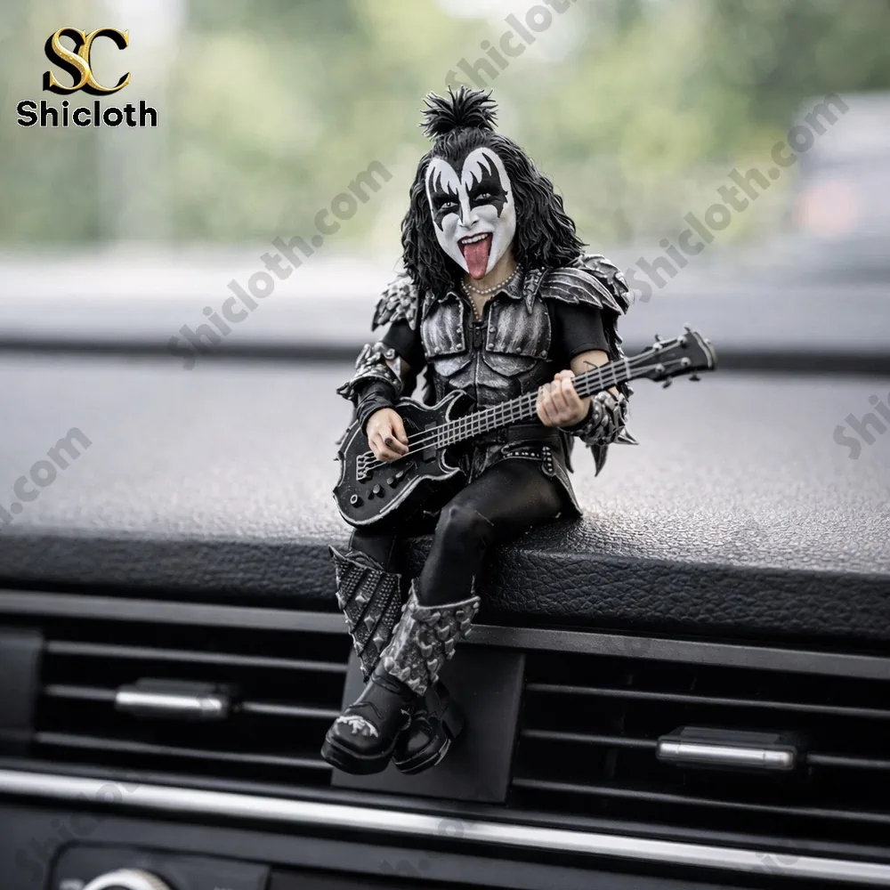 Rock band guitarist figurine playing bass on car dashboard!