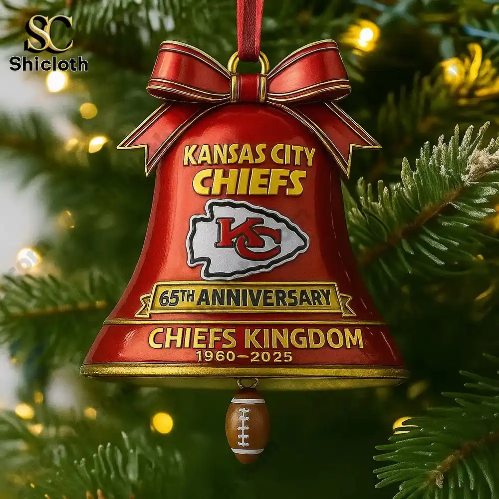 Close up of a Kansas City Chiefs anniversary bell ornament hanging on a tree.