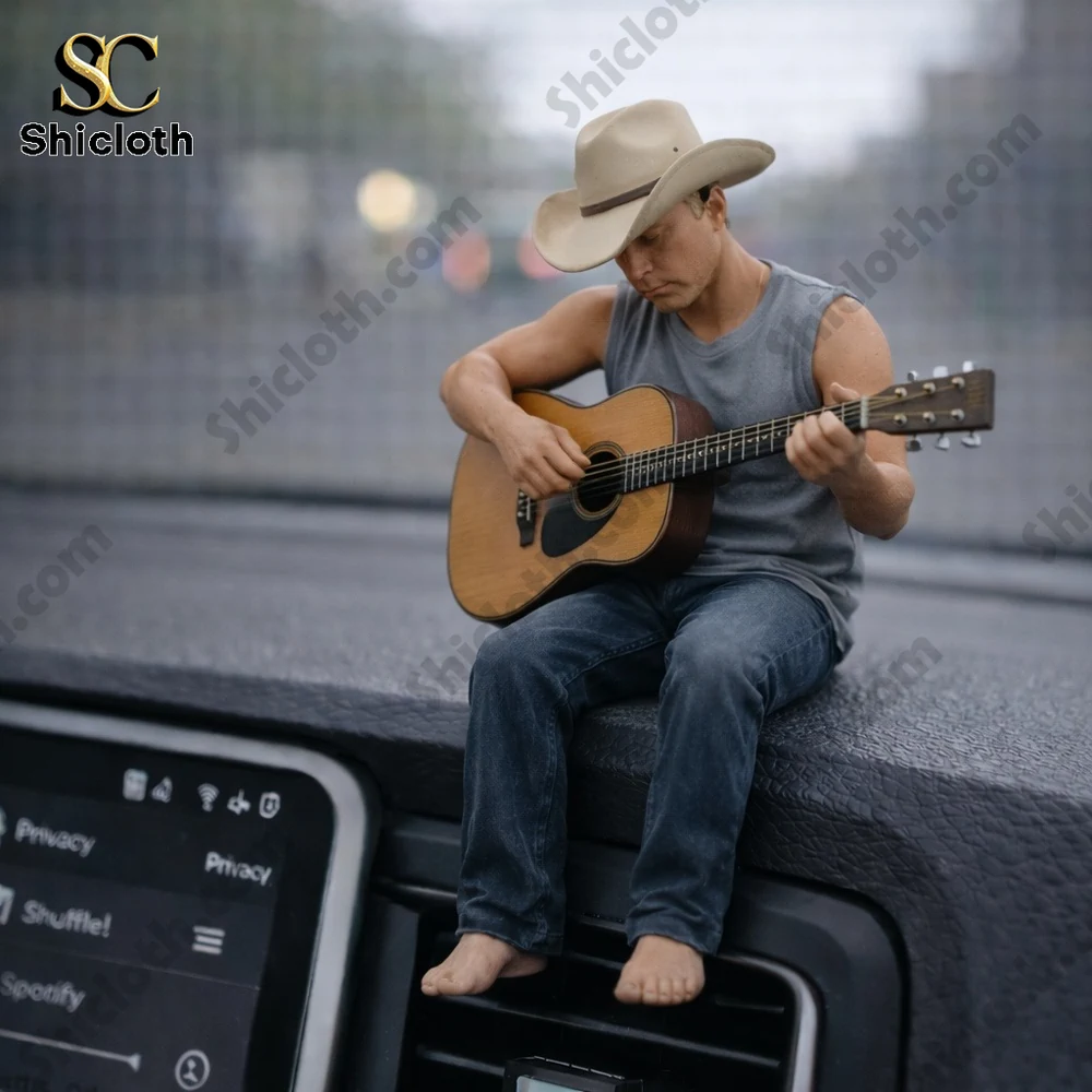 Tiny barefoot man playing acoustic guitar on car dashboard!