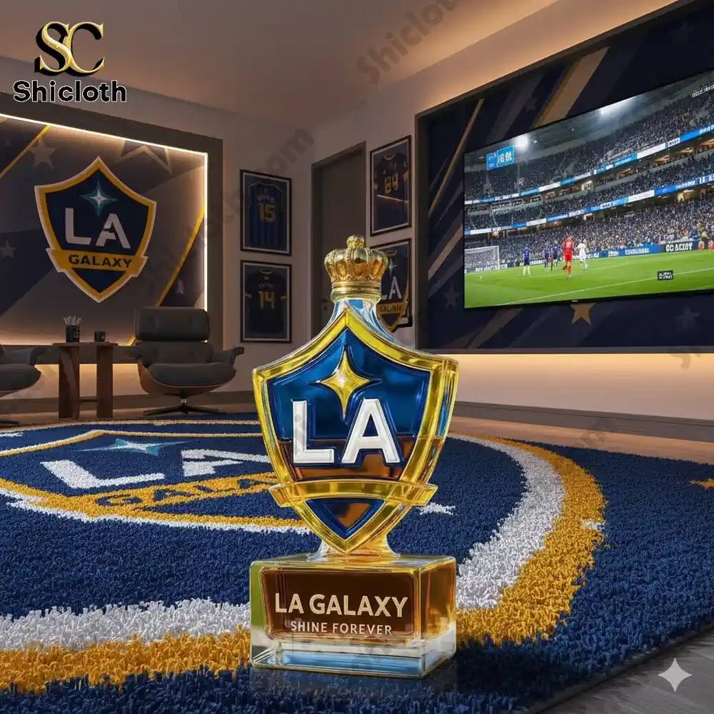 LA Galaxy whiskey bottle on a rug in a room with sports memorabilia and a football match on TV.