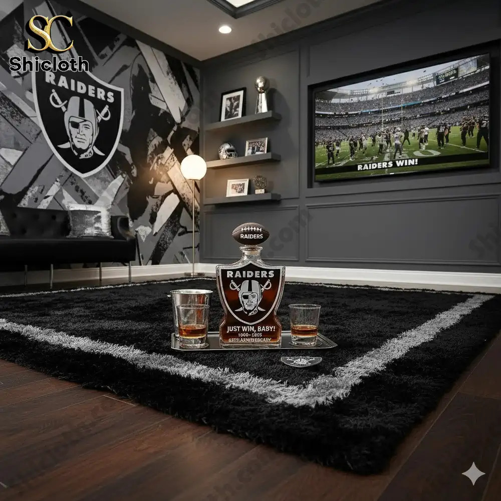 A stylish room with Raiders branding, featuring a whiskey bottle and glasses on a black rug.