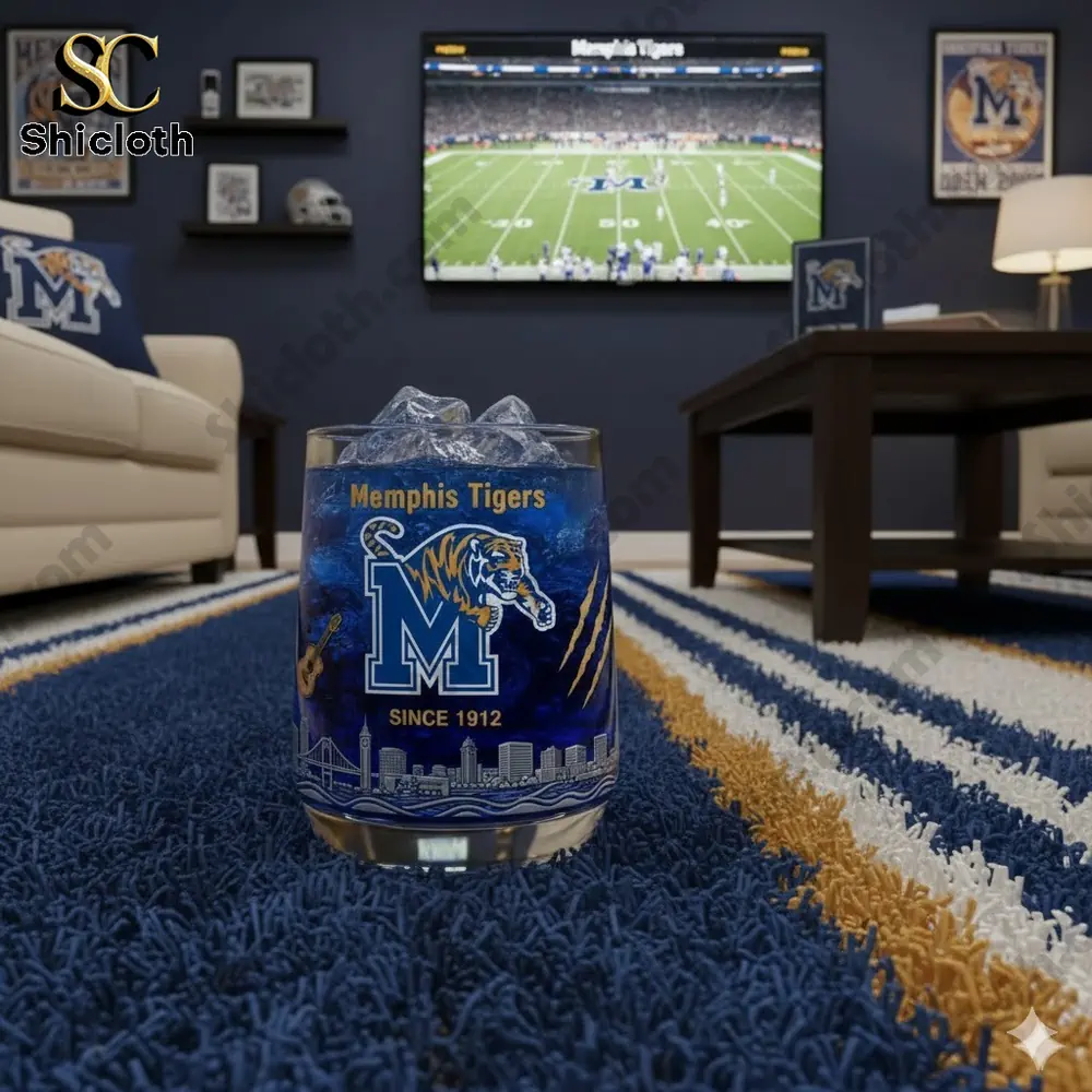 Glass with Memphis Tigers logo on a rug in a football themed living room!