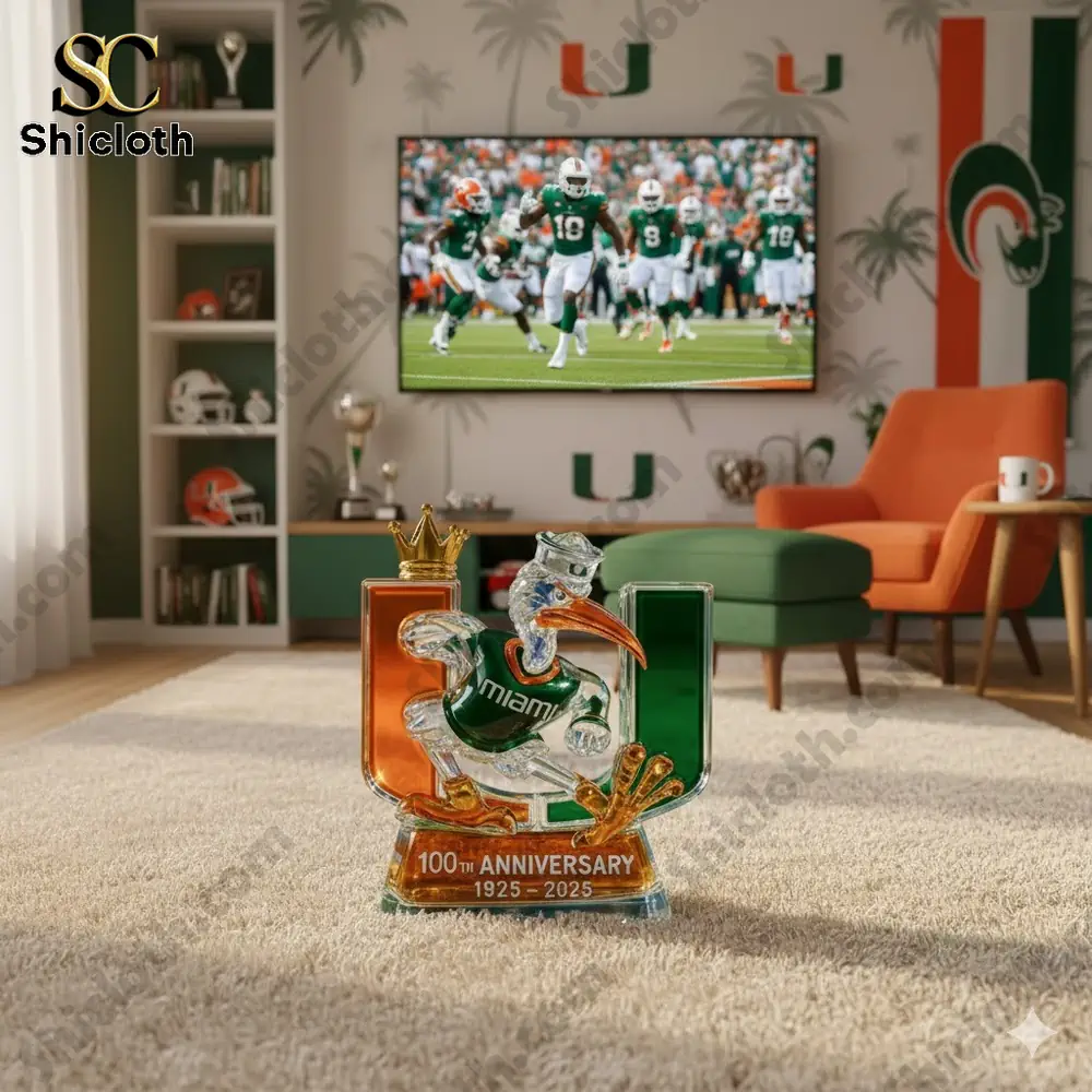A crystal Miami mascot figure with the U logo displayed in a living room with a football game on a television screen!