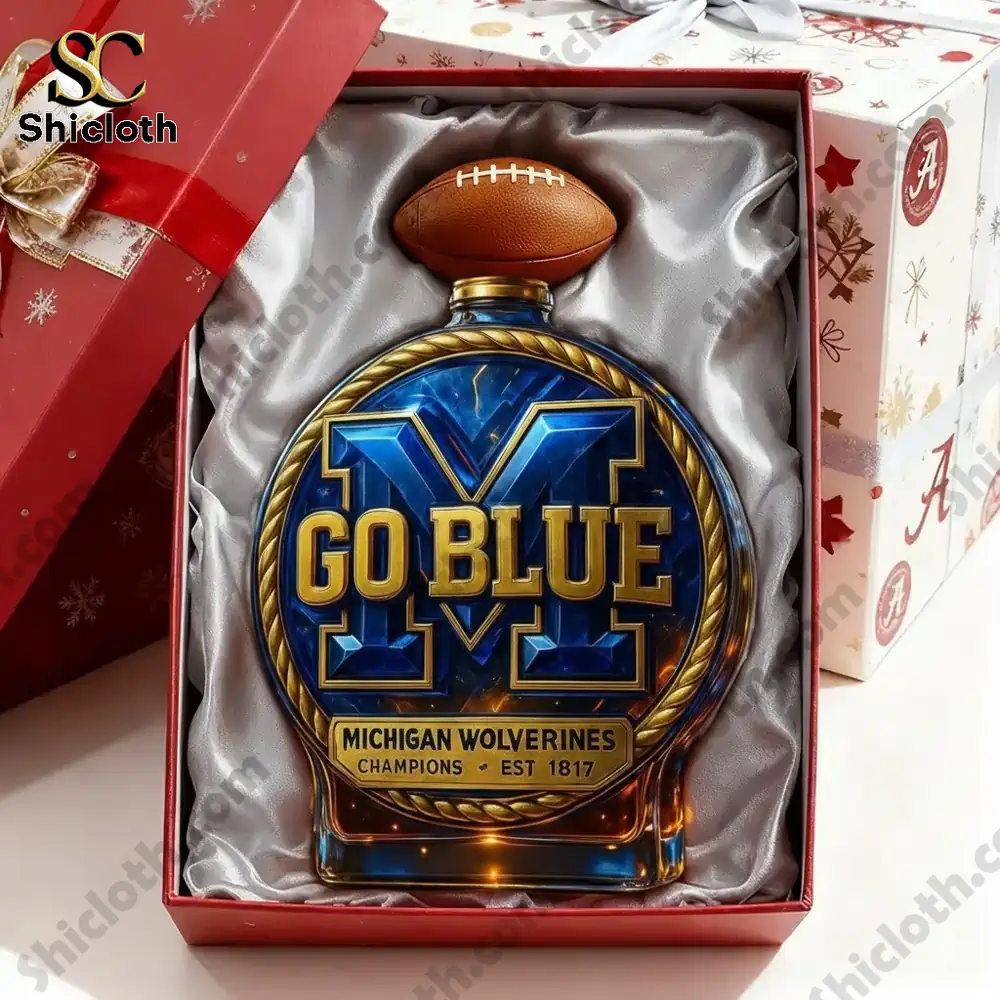 A gift box containing a Michigan Go Blue display piece with a football shaped top.