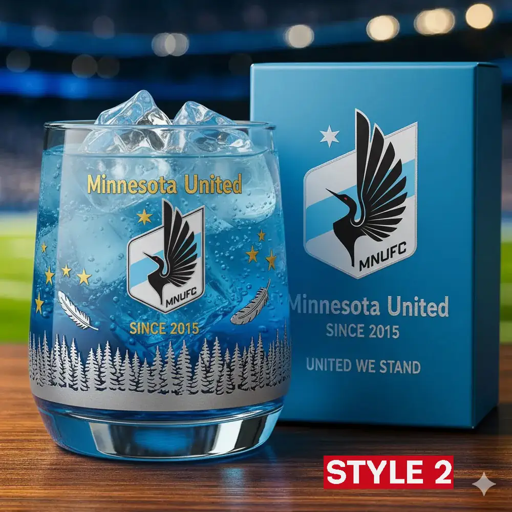 Minnesota United FC Christmas Whiskey Glass 4 Minnesota United glass with ice set in a stadium style background beside its product box.