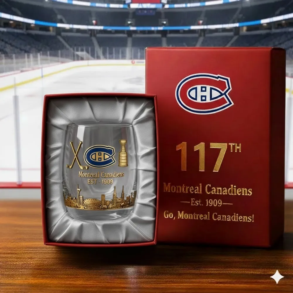 A Montreal Canadiens collectible glass displayed in a gift box on a wooden surface near an ice rink.