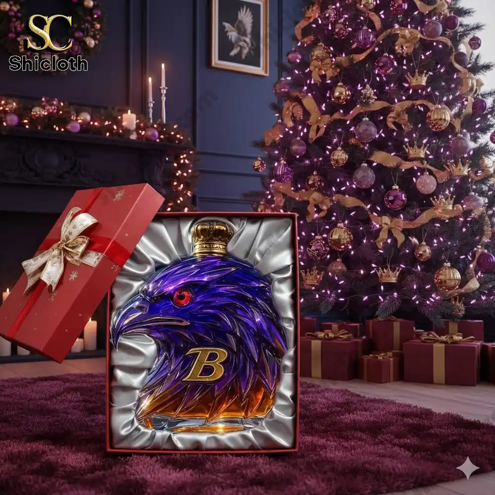 A purple and gold eagle shaped whiskey bottle in a gift box in front of a Christmas tree!