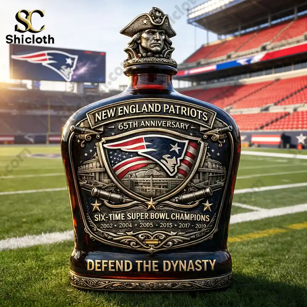 New England Patriots 65th Anniversary Defend the Dynasty whiskey bottle in front of the stadium with the Patriots logo on the scoreboard.
