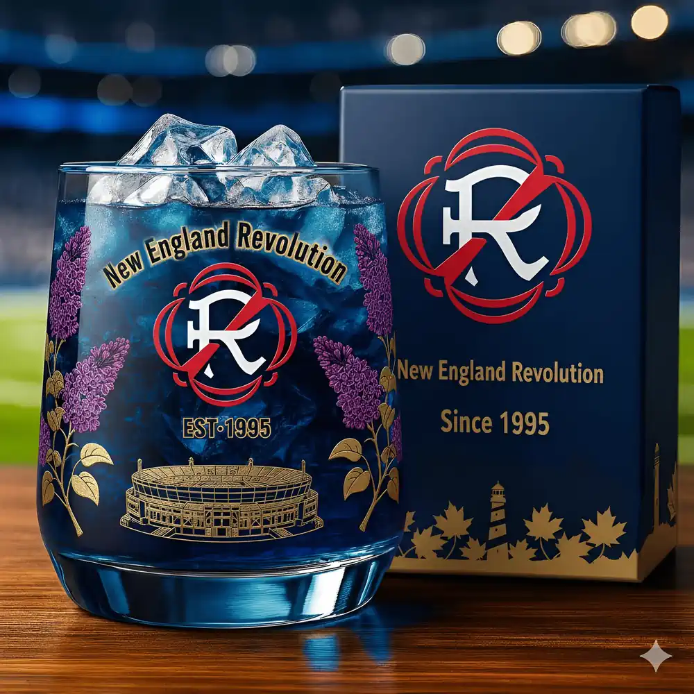 New England Revolution Christmas Whiskey Glass 3 A New England Revolution glass with ice beside its matching box on a wooden surface.