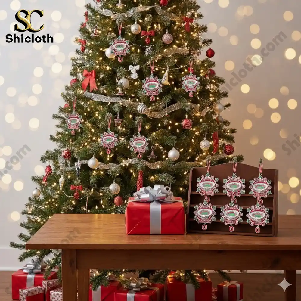 Christmas tree decorated with stadium themed ornaments and gift boxes on a wooden table in front!