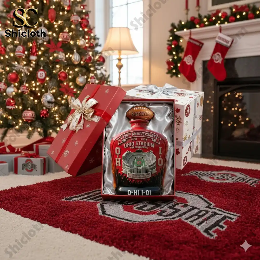 A decorated Ohio State Buckeyes 135th Anniversary whiskey bottle placed under a Christmas tree with festive surroundings.