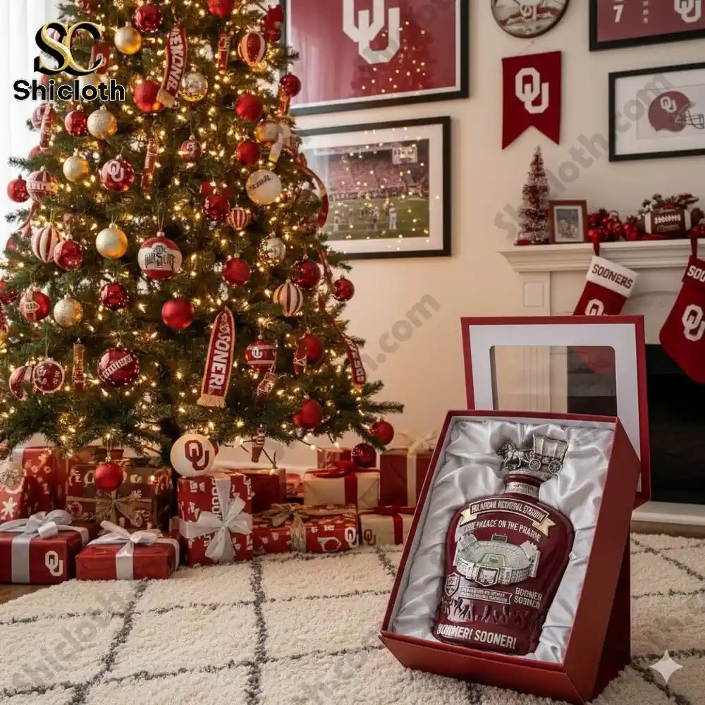 Christmas tree decorated with Oklahoma Sooners-themed ornaments and presents with a commemorative whiskey bottle featuring Oklahoma Memorial Stadium in the foreground.