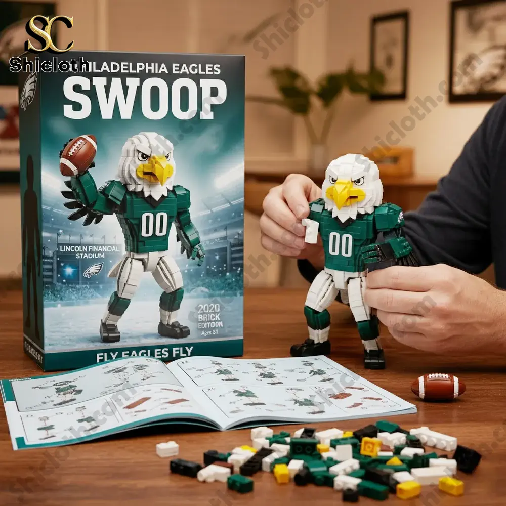 A person assembling a Philadelphia Eagles Swoop building block figure on a wooden table with instructions and a box!