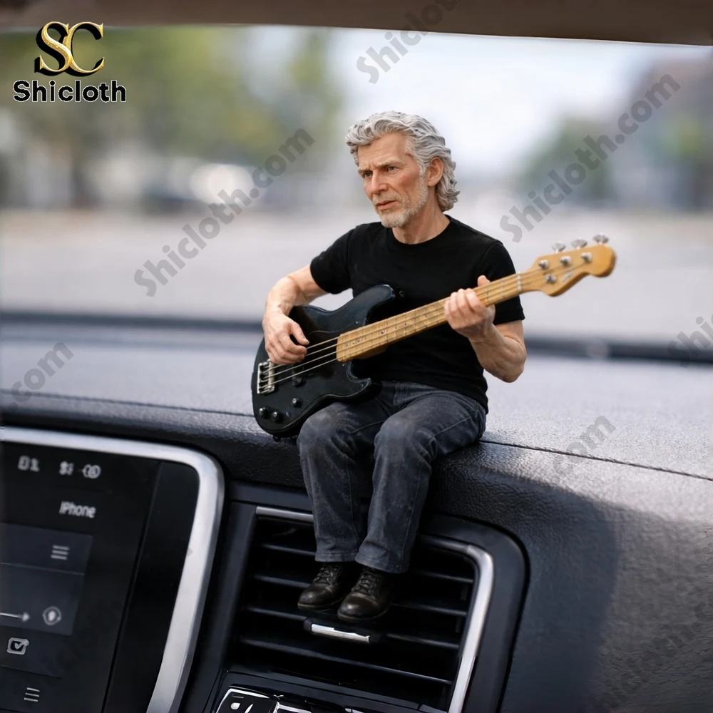 Miniature man playing bass guitar sitting on a car dashboard!