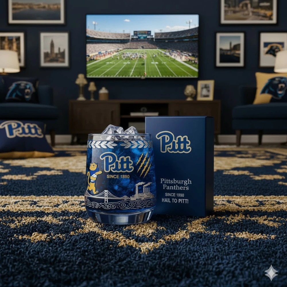 A Pitt themed glass filled with ice placed in a living room with a football game on a television in the background.