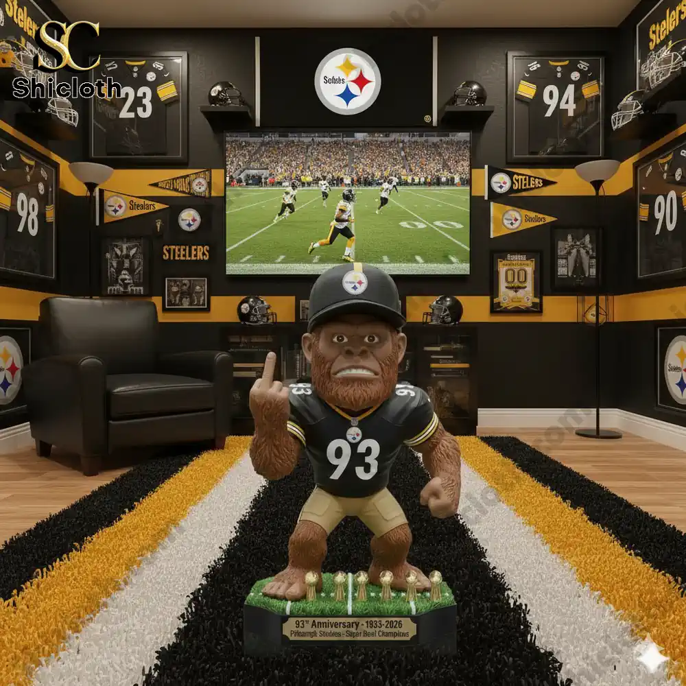 A Steelers themed fan cave featuring a Bigfoot mascot figure in the center of a black and gold room with jerseys and a TV.