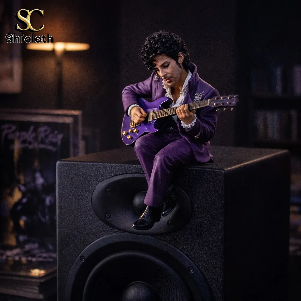 Purple suit musician figurine sitting on speaker with guitar!