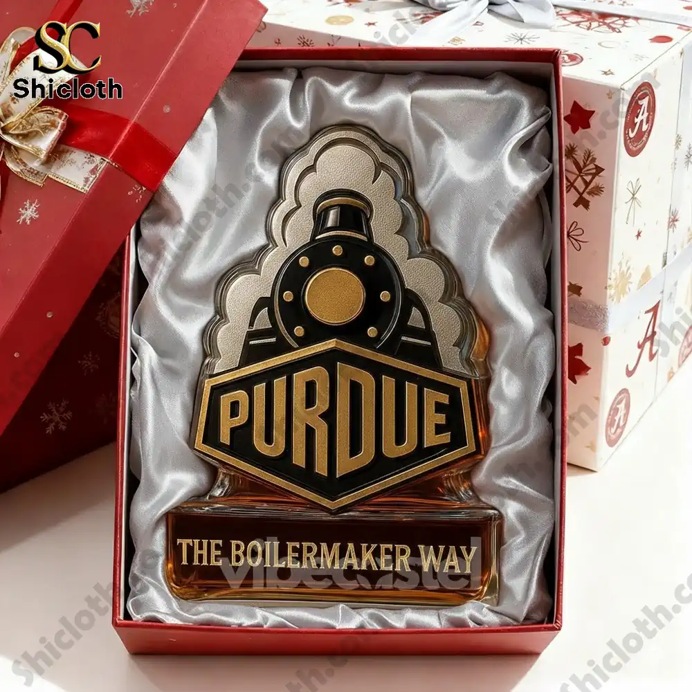A Purdue Boilermaker whiskey bottle inside a red gift box with a shiny ribbon.
