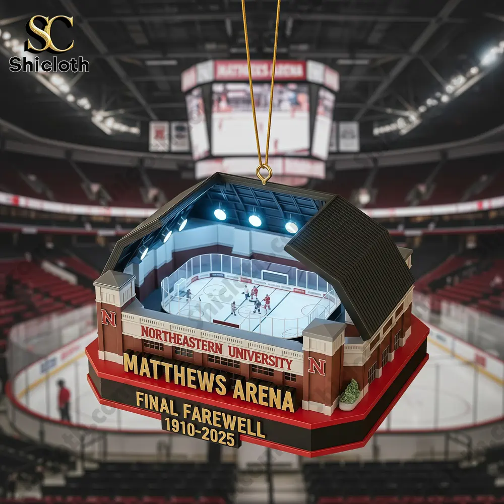 A Matthews Arena Final Farewell Christmas ornament featuring a miniature arena with lights, displayed with a Christmas tree in the background.