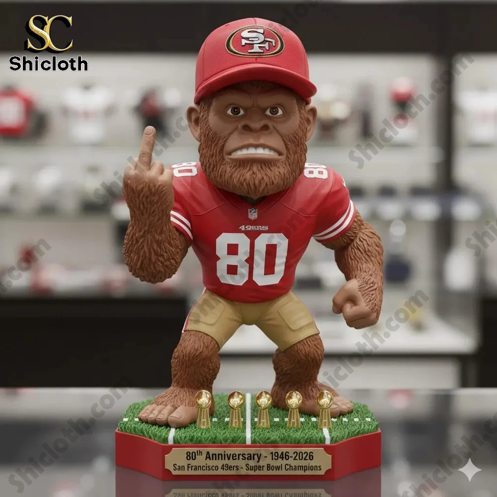 Bigfoot figure wearing San Francisco 49ers jersey number 80 and red hat while raising middle finger on a trophy base!