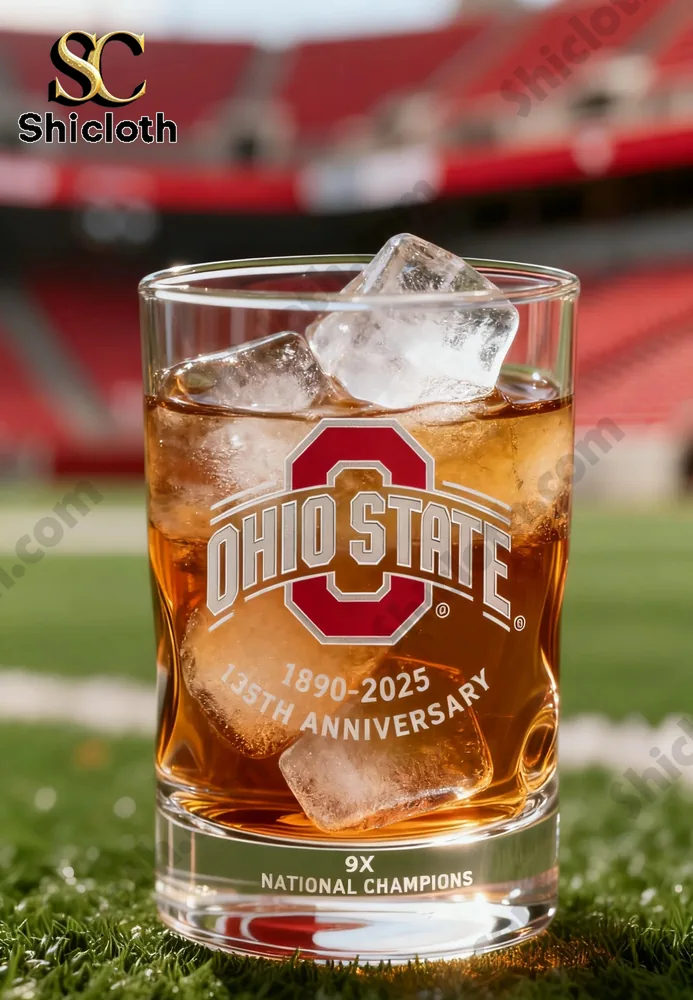 Ohio State branded glass with ice cubes filled with a drink, placed on a football field background.