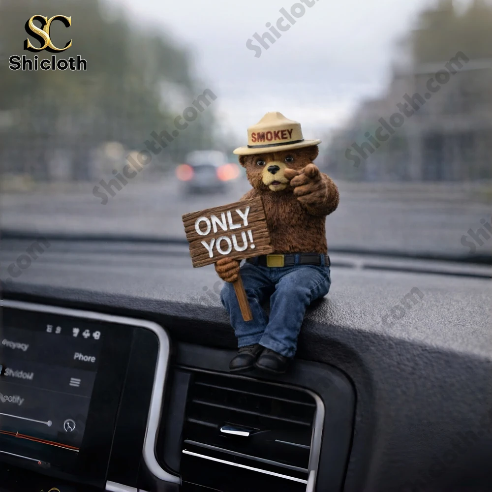 Smokey bear figurine holding only you sign on car dashboard!