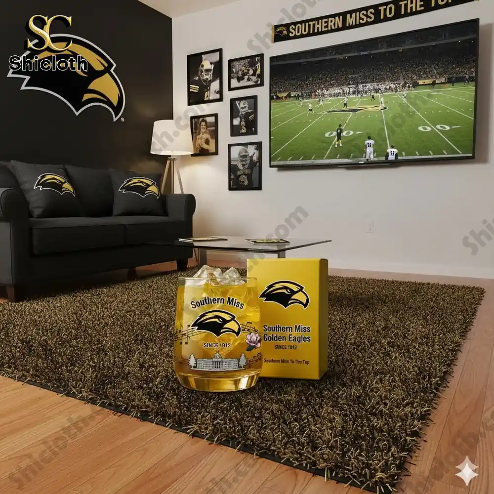 A living room decorated in Southern Miss theme with a large logo on the wall a game on TV and team branded items on the rug!