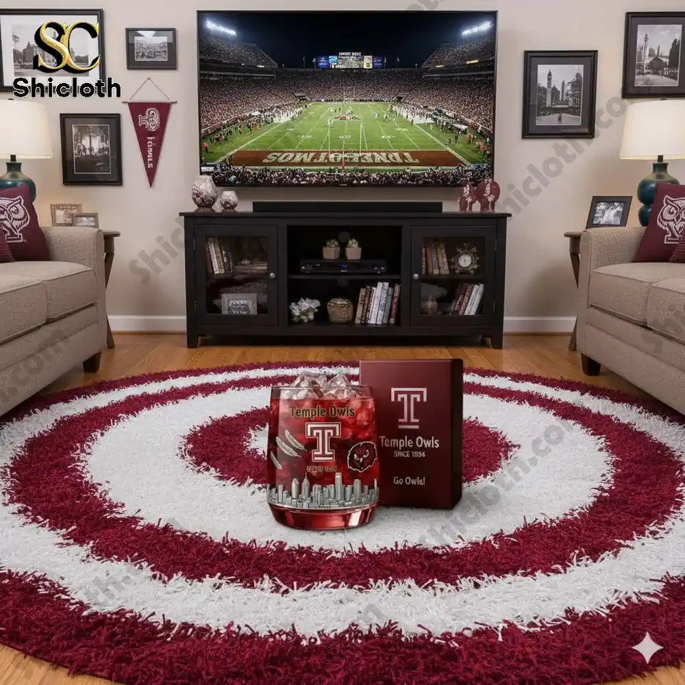 A living room with Temple Owls decorations and a football game on a television screen!