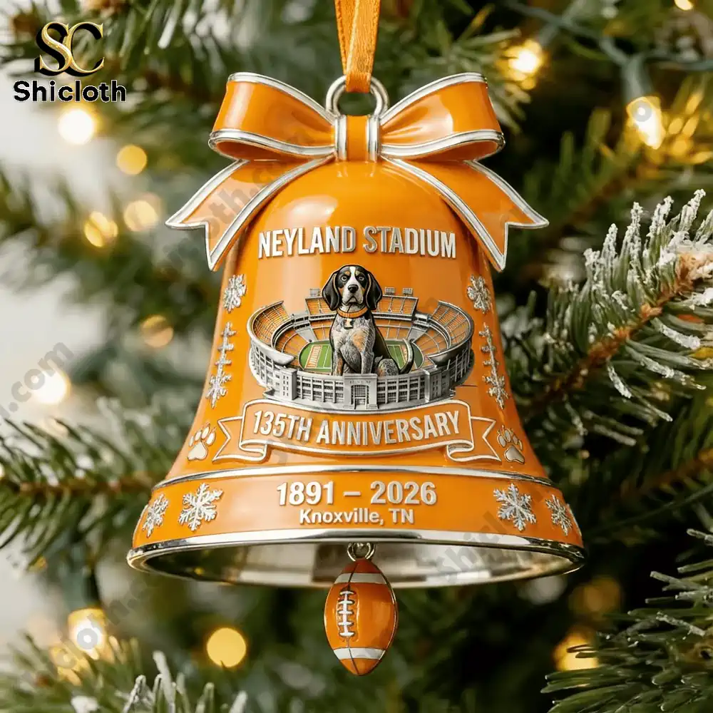 Close up of an orange Neyland Stadium anniversary bell ornament hanging on a Christmas tree.