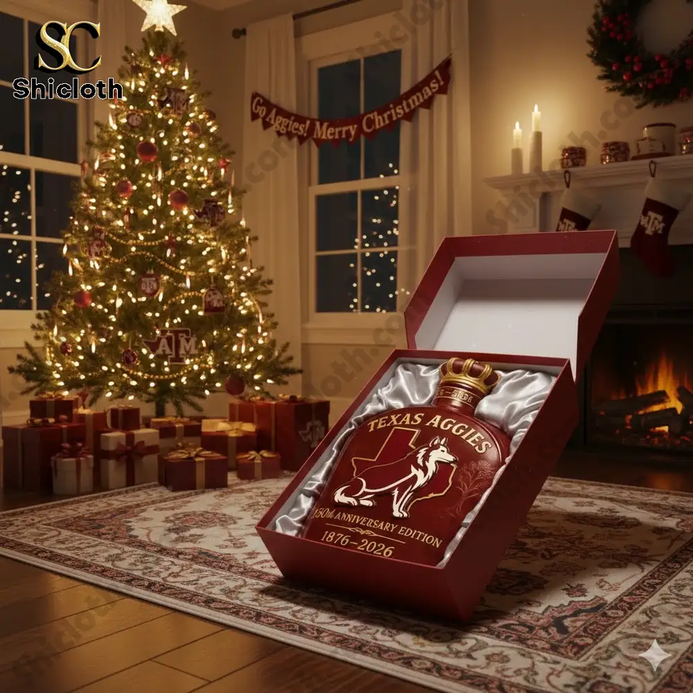 A Texas A&M 150th Anniversary Whisky Bottle displayed in a red box under a Christmas tree surrounded by presents.
