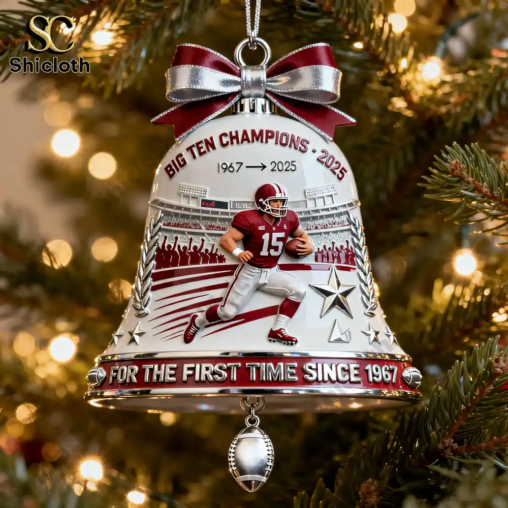 A close view of a football themed bell ornament on a Christmas tree