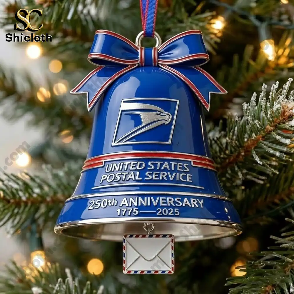 Close up of a blue USPS anniversary bell ornament hanging on a Christmas tree!