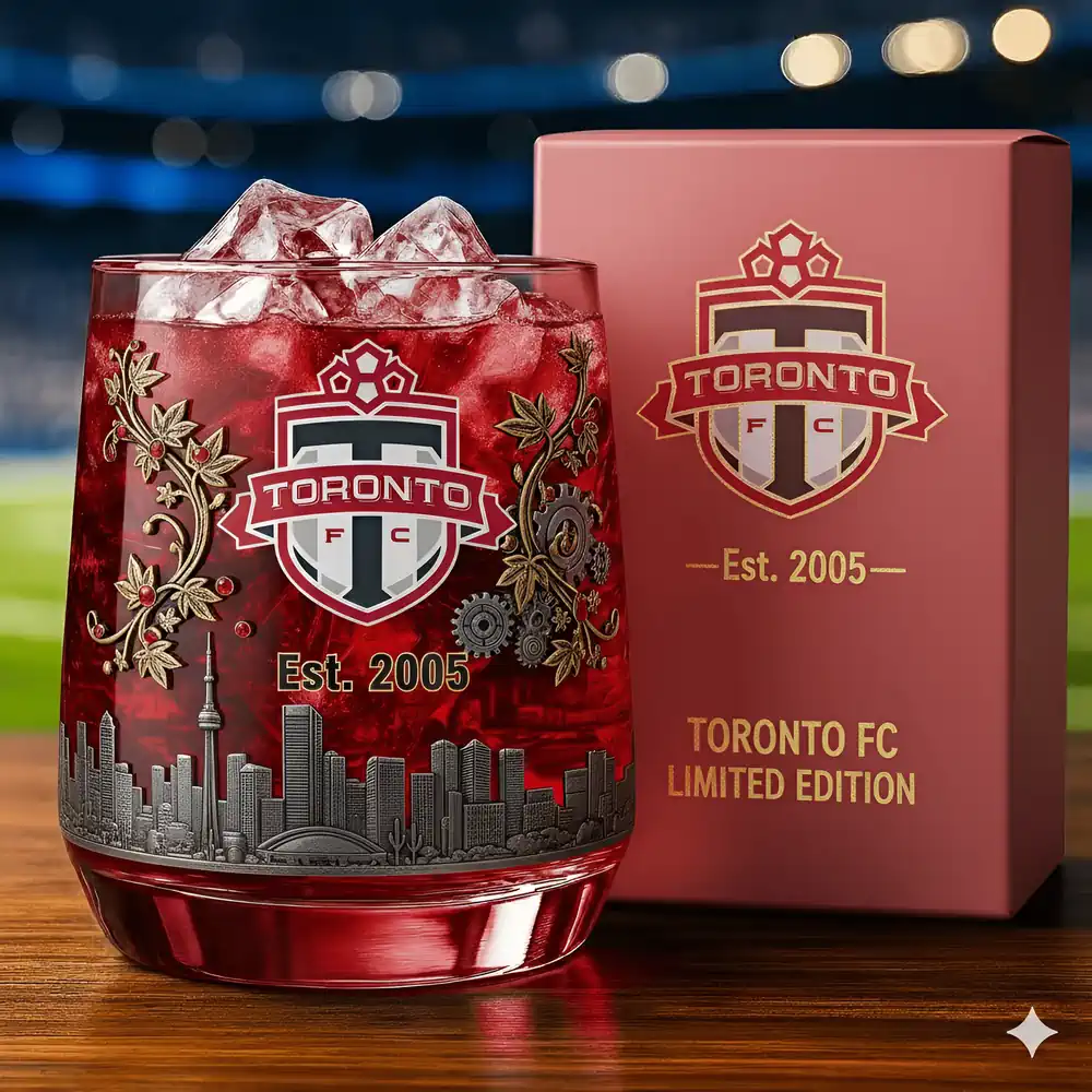 Toronto FC Christmas Whiskey Glass 3 A Toronto FC limited edition glass filled with red iced drink beside its box.