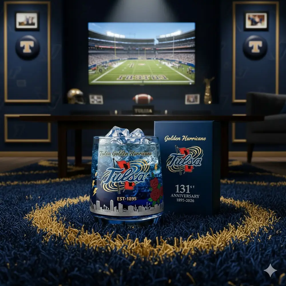 A Tulsa Golden Hurricane anniversary glass displayed in a sports themed room with a stadium screen in the background!