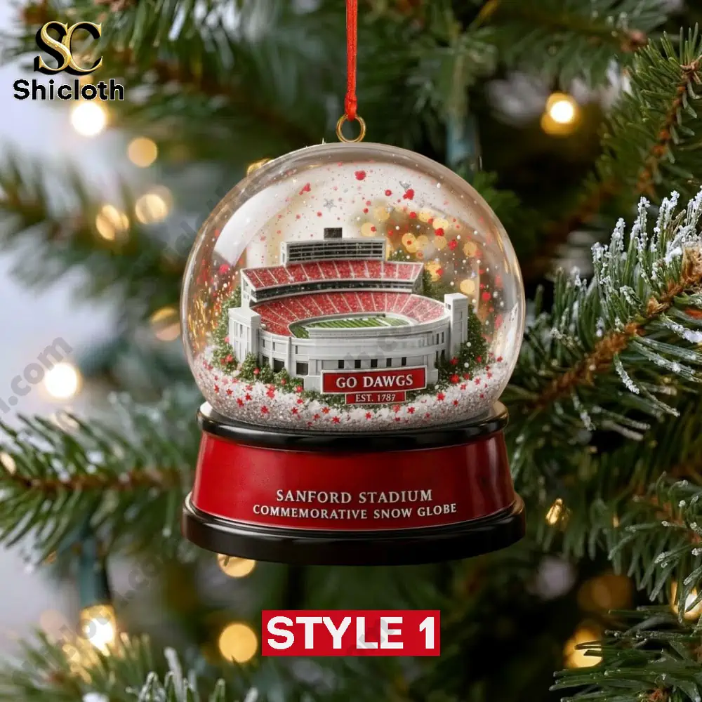 A hanging snow globe ornament featuring Sanford Stadium with red and white details on a Christmas tree.