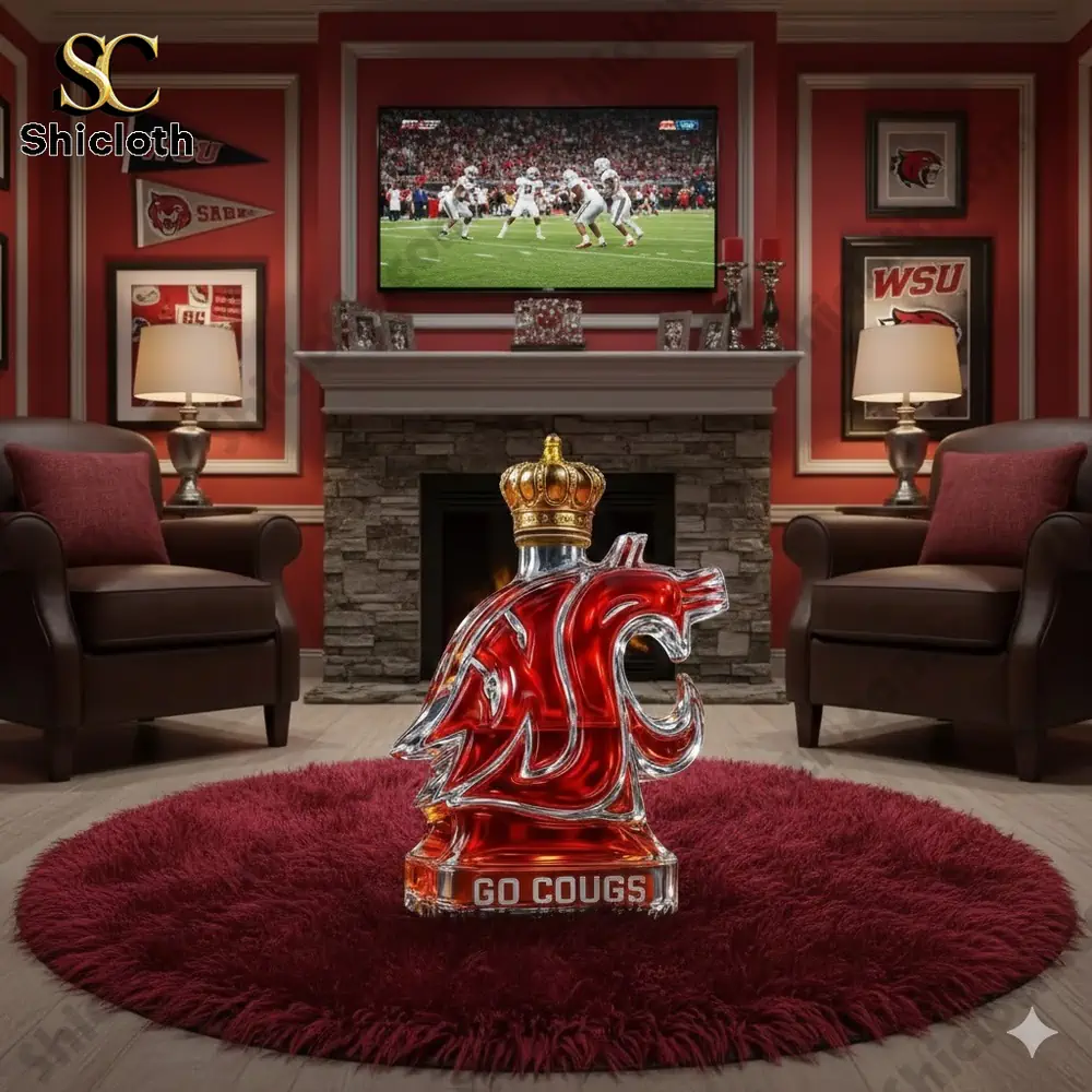 A glass display shaped like a cougar logo with red liquid sits on a round red rug in a sports themed room!