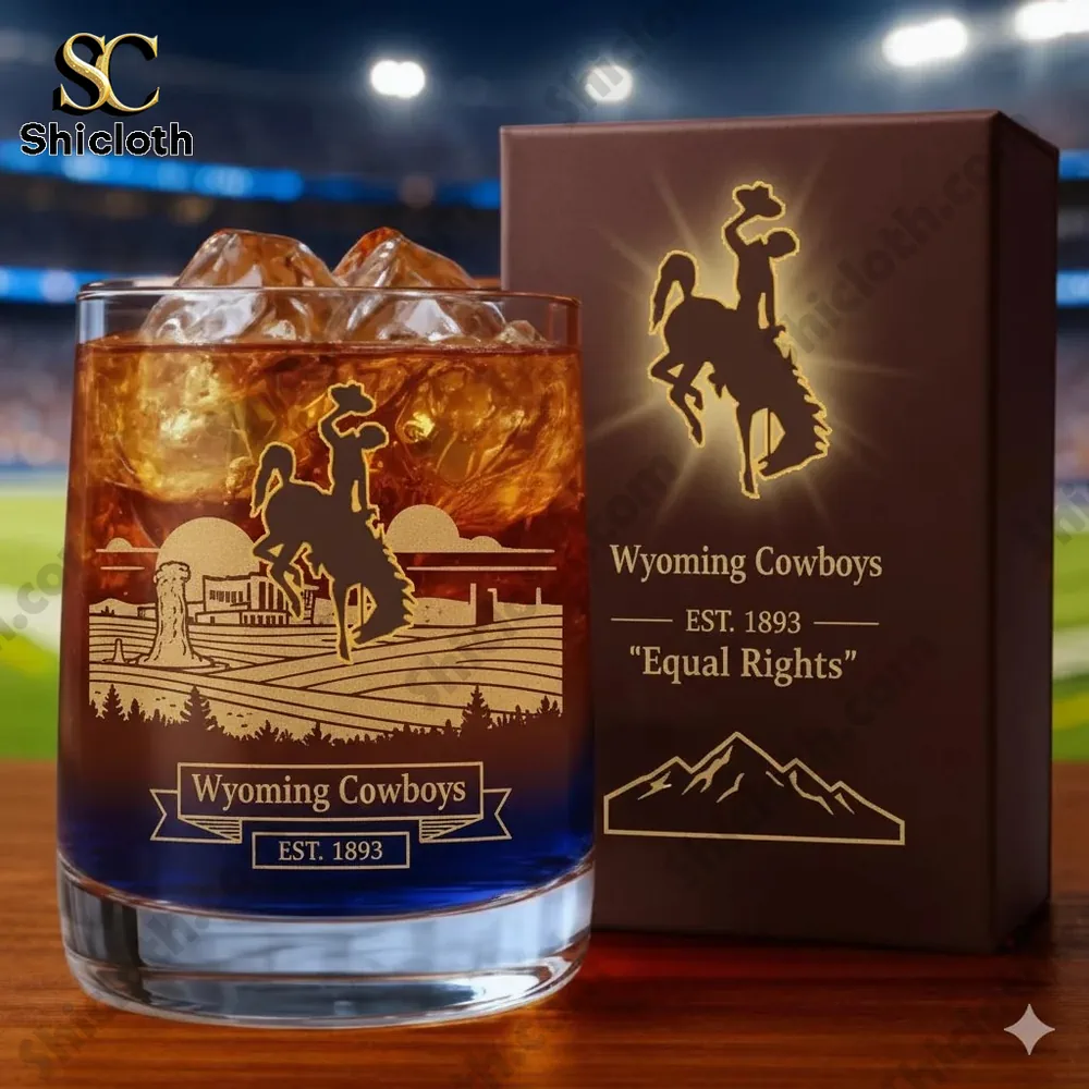 Wyoming Cowboys whiskey glass with ice and branded box on wooden table!