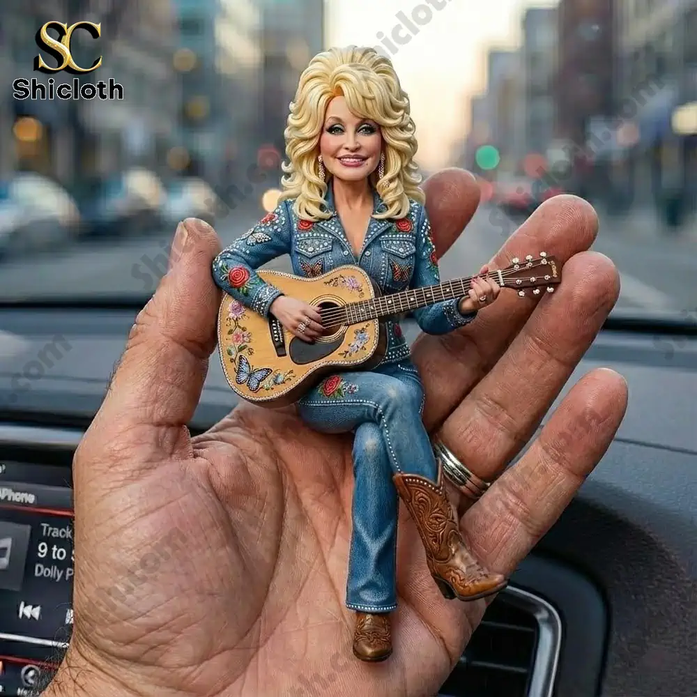 Mini country singer doll playing guitar in a hand inside a car!