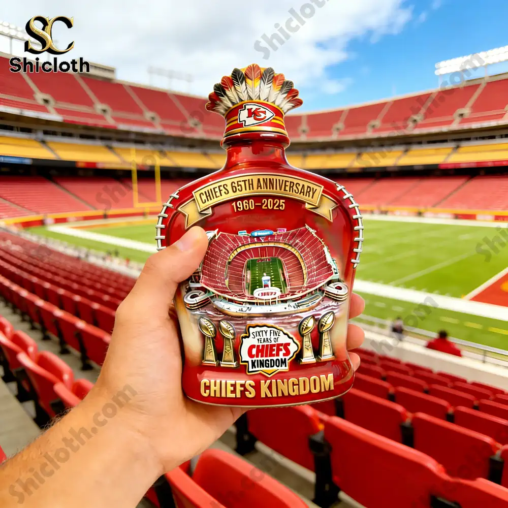 Hand holding a Chiefs Kingdom anniversary decorative jar inside a football stadium!