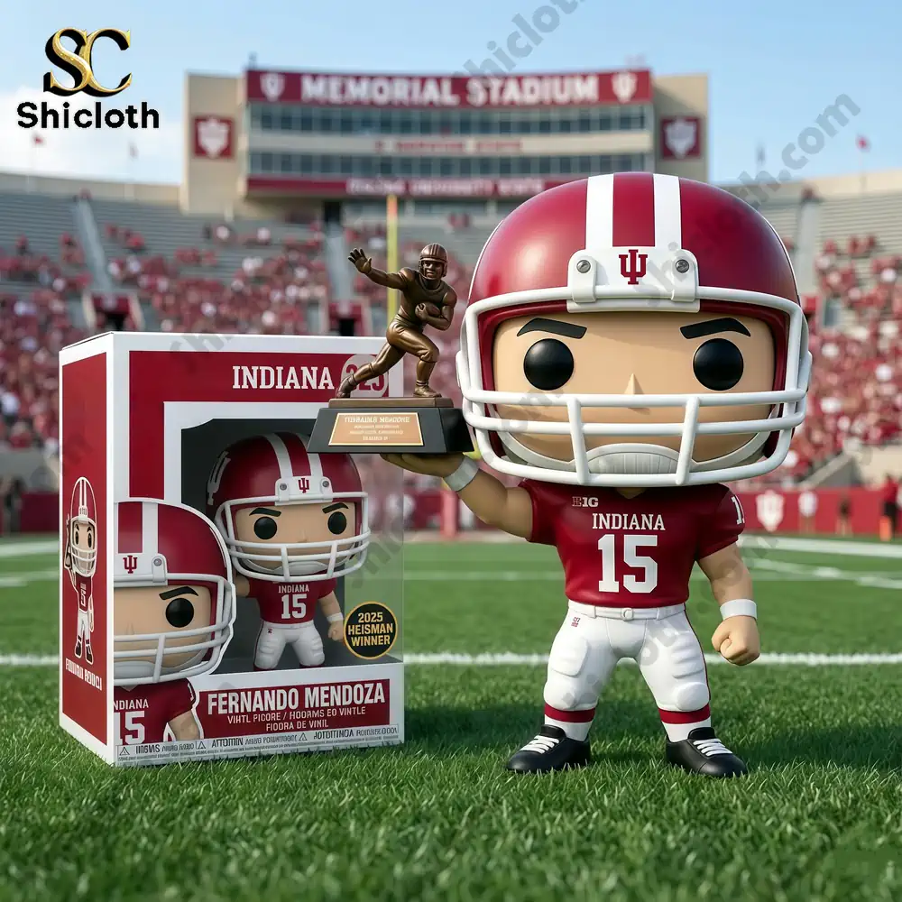 Football player holding Heisman trophy in front of Memorial Stadium with Indiana team decorations and pop figure box.