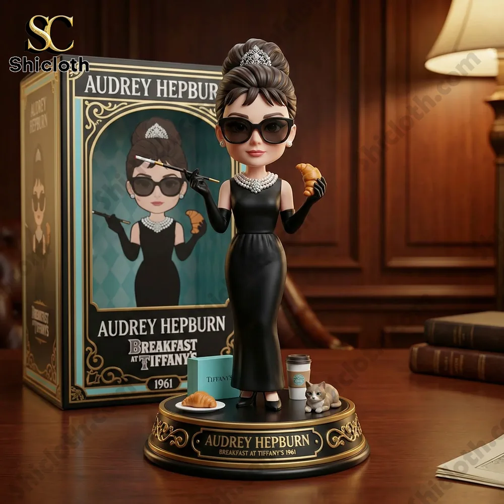 Elegant black dress figure holding a croissant on a desk!