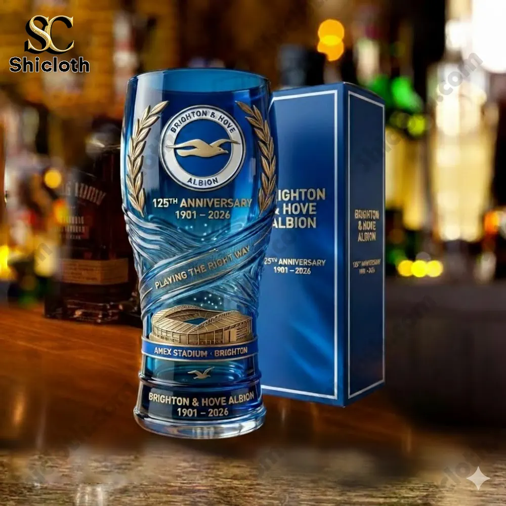 Blue anniversary beer glass with Brighton and Hove Albion crest on a bar counter!