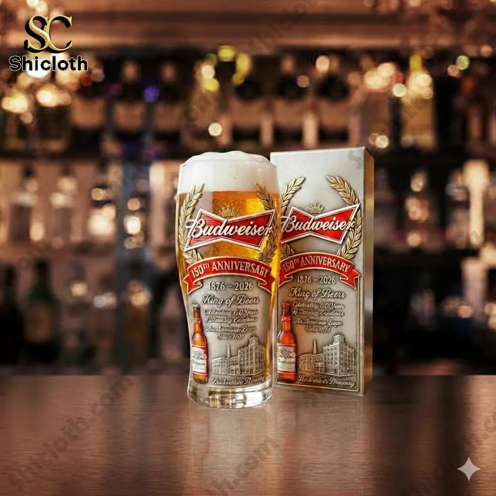 Budweiser anniversary beer glass with foam on bar counter!