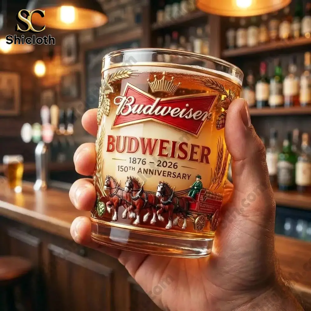 Hand holding Budweiser anniversary beer glass in bar!