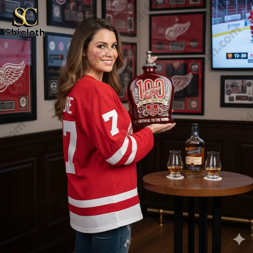 Fan holding red wings centennial whiskey decanter in sports room!