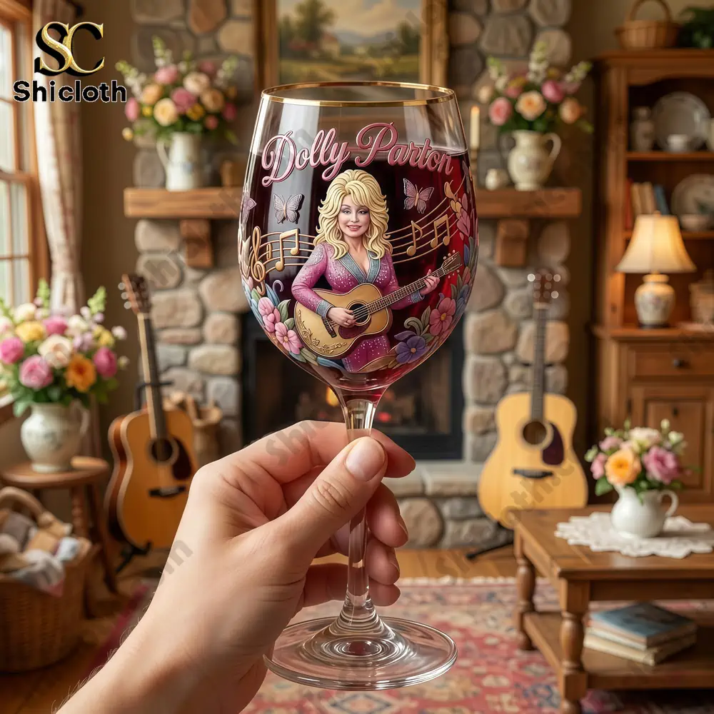 Hand holding Dolly Parton themed wine glass in cozy music room!